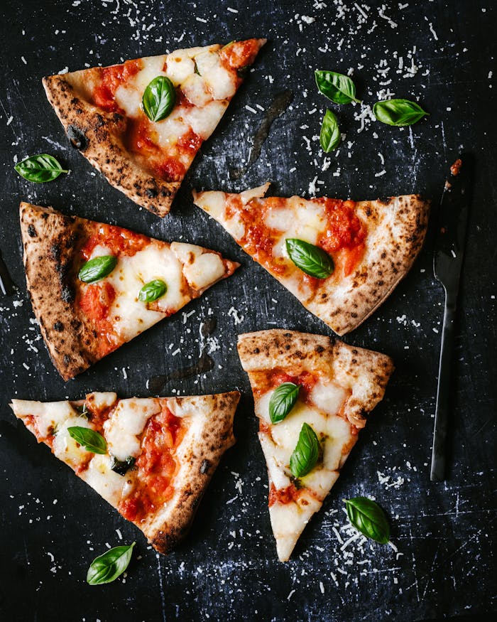 Delicious pizza slices with fresh basil, perfect for food lovers and culinary photography.